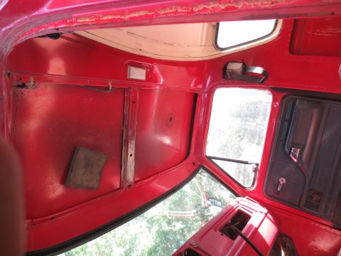 1978 Ford Bronco - The interior of a vehicle is shown, with a focus on the red painted surfaces and window frames.