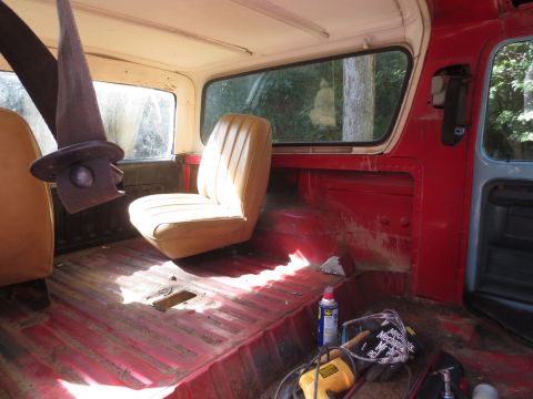 1978 Ford Bronco - The interior of a 1978 Ford Bronco is shown, with the passenger seat and rear floor visible.