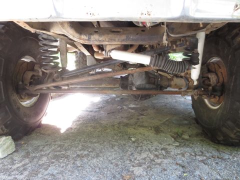 1978 Ford Bronco - The undercarriage of a 4x4 vehicle shows its suspension and steering components.