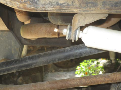 1978 Ford Bronco - A close-up view of the undercarriage reveals various mechanical parts and signs of wear.