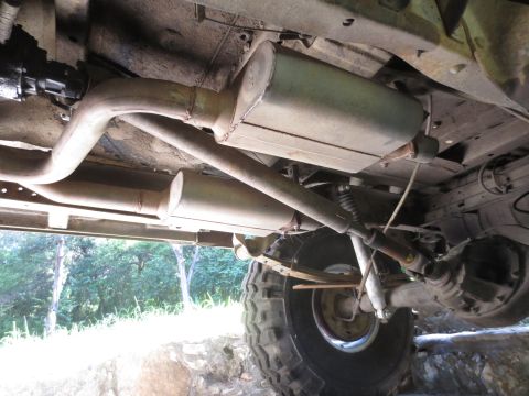 1978 Ford Bronco - Undercarriage view shows the dual exhaust system and leaf springs of a vehicle, with a SuperMotors watermark visible.