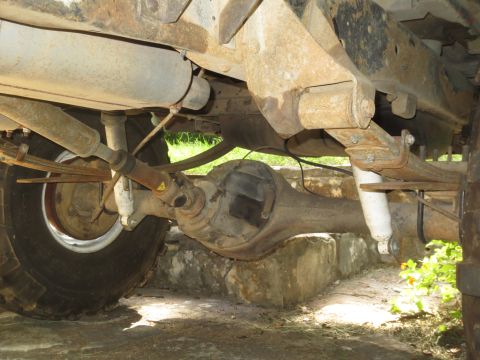 1978 Ford Bronco - Close-up of the rear suspension and drivetrain components of an older vehicle.