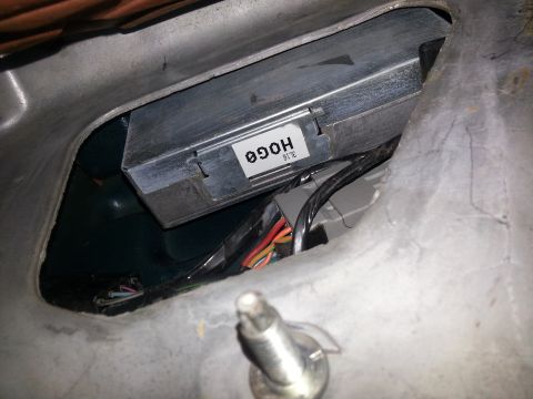 1994 Ford Bronco - Close-up of an engine control module with visible wiring and a part number label.