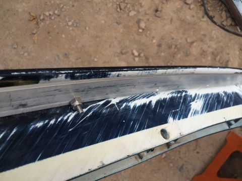 1995 Ford Bronco - A close-up view of a damaged vehicle part, a bolt and the Supermotors.net logo, with visible scratches on its surface.