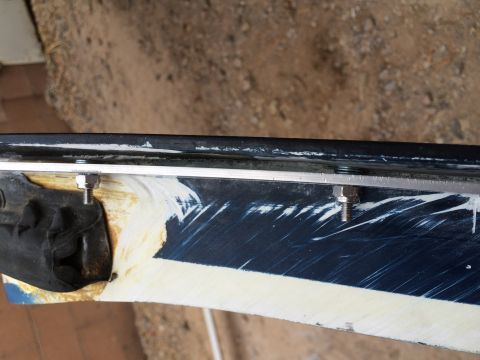 1995 Ford Bronco - Close-up of a modified vehicle body panel, showing repair work and bolted attachments.