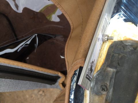 1995 Ford Bronco - Detail of the soft top interior, showing a metal bracket with visible text and a bolt.