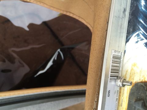 1995 Ford Bronco - Close-up of a vehicle's soft top interior, showing fabric and a clear window.