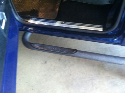 1982 Ford Bronco - Close-up view of the interior door sill and side step of a blue vehicle.