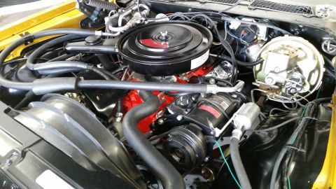 1970 Chevrolet Camaro - Close-up view of a V8 engine bay, the air cleaner assembly and air conditioning compressor.