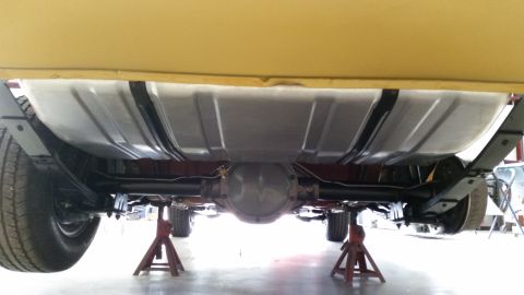 1970 Chevrolet Camaro - The underside of a vehicle is visible, a large fuel tank and rear suspension components.