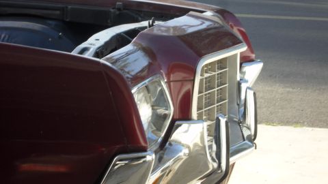 1972 Ford Ranchero - The front of a maroon vehicle is shown, with the hood open, revealing the engine bay.