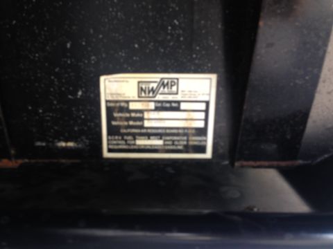 1986 Ford Bronco - A close-up of a vehicle emissions label with some text visible, including 'NWMP' and 'CALIFORNIA AIR RESOURCES BOARD'.
