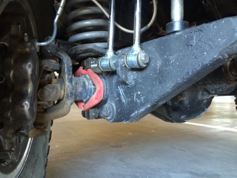 1995 Ford Bronco - Undercarriage view shows a vehicle's front suspension components, including sway bar links and bushings.