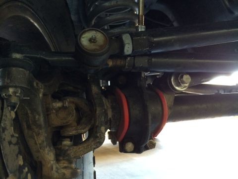1995 Ford Bronco - Close-up of the undercarriage shows the vehicle's steering and suspension system components.
