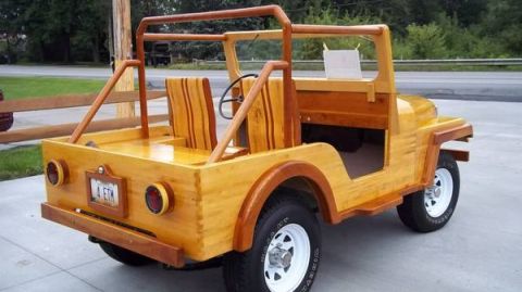 Wooden buggy with two seats, roll cage, and a license plate that reads 'A ETH'