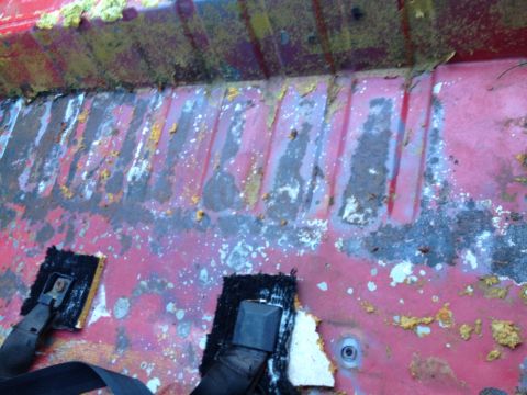 1978 Ford Bronco - Interior floor pan shows significant rust and wear, with seatbelt anchors still attached.