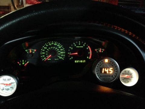 2002 Ford Mustang - Dashboard of a 2002 Ford Mustang showing the speedometer, tachometer, and additional gauges.