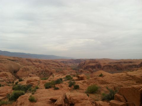 2005 Jeep Wrangler - A vast desert landscape with layered rock formations and a canyon in the distance.