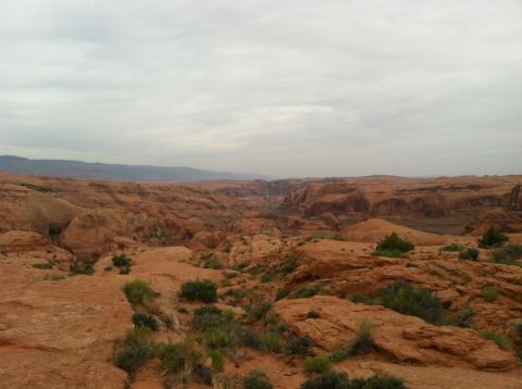 2005 Jeep Wrangler - View of a desert landscape with rock formations and a canyon under an overcast sky.