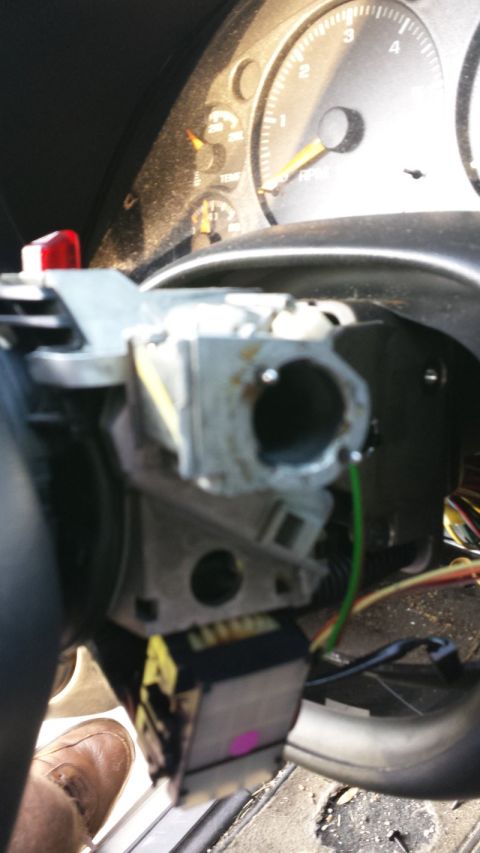 2000 GMC Jimmy - The ignition switch assembly is removed from the steering column, revealing wiring and part of the dashboard.