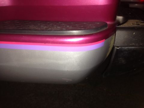 1992 Ford F-150 - Close-up of a vehicle's rear bumper corner, showing decorative stripes and trim.