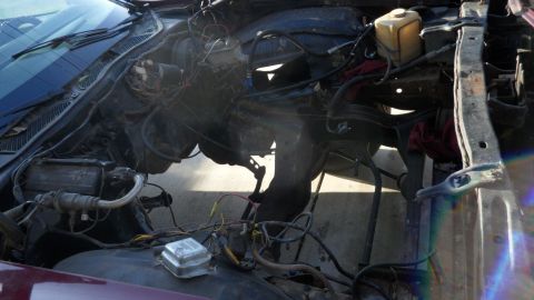 1972 Ford Ranchero - The engine bay of a vehicle is shown with many components removed and wiring exposed.