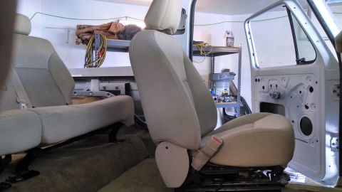 1979 Ford Bronco - Interior view of a vehicle with seats and door panels removed, showing the bare structure.