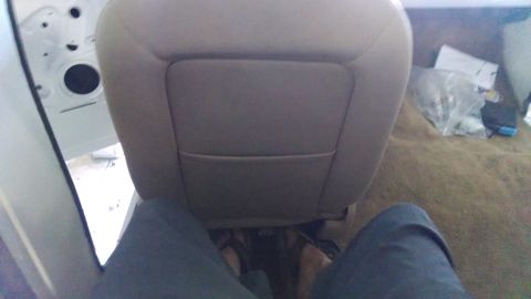 1979 Ford Bronco - The interior of a vehicle is shown, focusing on the passenger seat and the surrounding cabin area.