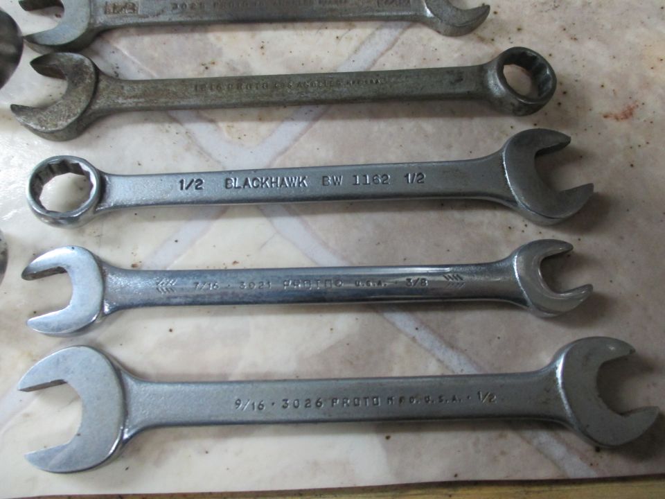Several open-end and box wrenches laid out, including Blackhawk and Proto brands