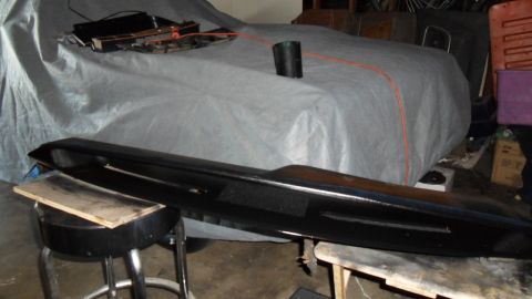 1972 Ford Ranchero - A vehicle is covered with a tarp in a cluttered garage setting.