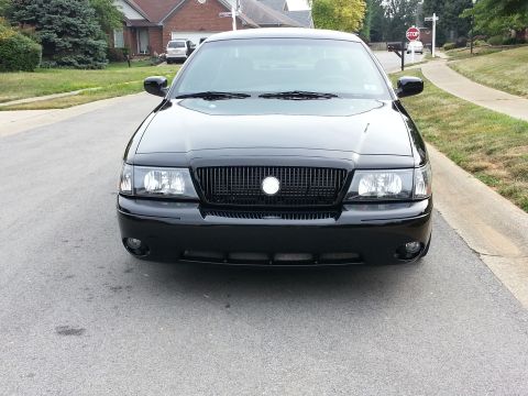 2003 Mercury Marauder - Frontal view of a black 2003 Mercury Marauder sedan parked curbside on a residential street.