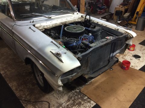 1964 Ford Fairlane - Front end of a 1964 Ford Fairlane undergoing restoration, engine exposed.