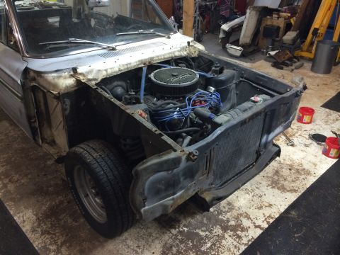 1964 Ford Fairlane - The front end of a 1964 Ford Fairlane is disassembled, revealing the engine and surrounding components.
