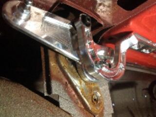 1964 Ford Fairlane - Close-up of a chrome door latch mechanism, showing its intricate design and mounting hardware.