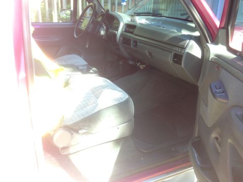 1992 Ford F-150 - The interior of a 1992 Ford F-150, the dashboard, steering wheel, and front seats.