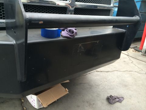 1997 Dodge 3500 - A close-up view of a black aftermarket front bumper, showing some wear and tear.