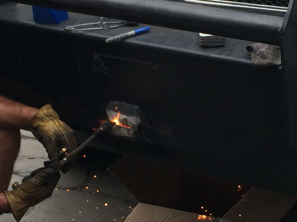 Welding a metal part onto a black bumper