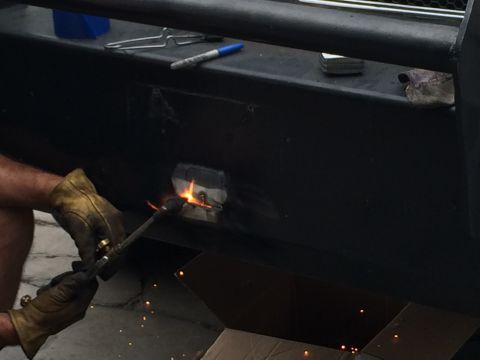 1997 Dodge 3500 - Welding repair on a heavy-duty black metal bumper.