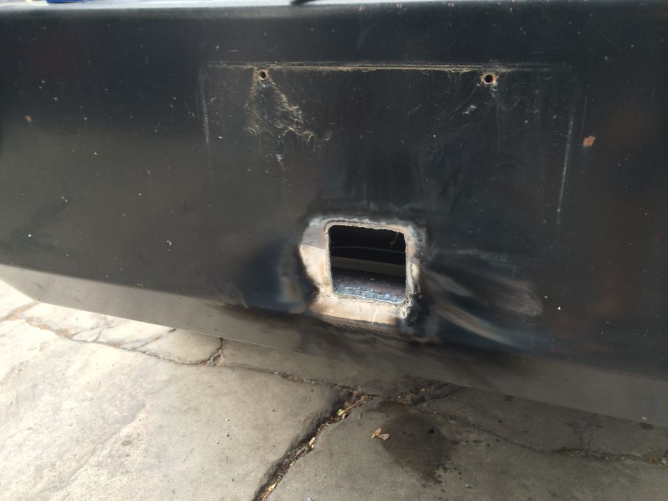 Black bumper with a square cutout and visible weld marks