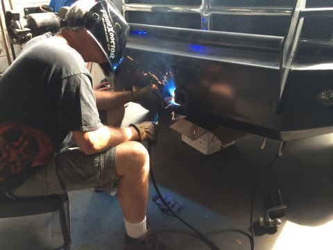 1997 Dodge 3500 - Custom bumper fabrication in progress, showing a welder at work.