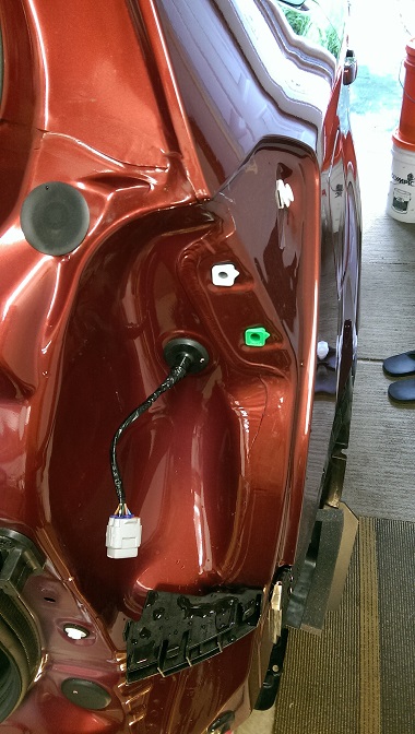 2015 Subaru Forester - Close-up view of the rear bumper area, showing a wiring harness and electrical connectors.