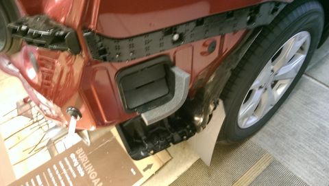 2015 Subaru Forester - The rear bumper assembly has been detached, revealing the vehicle's internal structure and a tire.