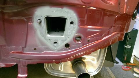 2015 Subaru Forester - Close-up of the rear frame of a 2015 Subaru Forester, showing the hitch receiver opening and exhaust.