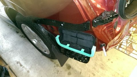 2015 Subaru Forester - Rear bumper removed from a 2015 Subaru Forester, revealing the underlying structure and protective foam.