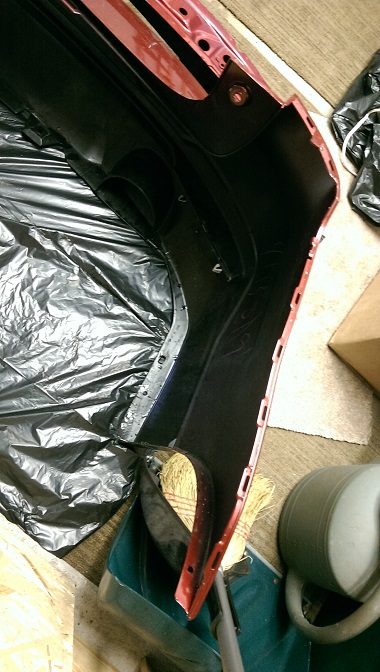 2015 Subaru Forester - A detached car bumper is shown indoors, resting on protective sheeting.
