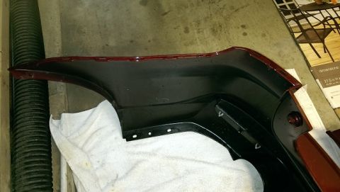 2015 Subaru Forester - A dark red rear bumper part is shown with black interior sections and mounting holes.