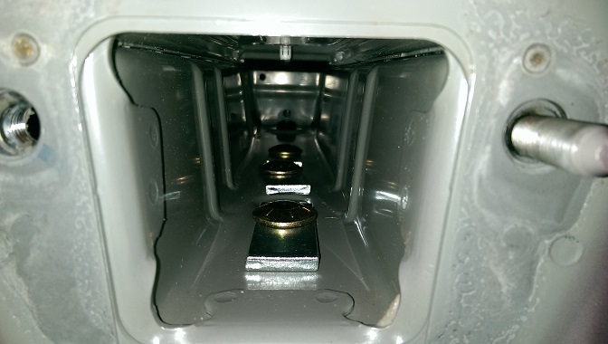 Vehicle hitch receiver interior with bolts and mounting brackets visible
