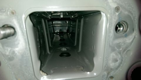 2015 Subaru Forester - Close-up view of an empty rectangular opening within a vehicle's frame, showing internal structural details and mounting hardware.