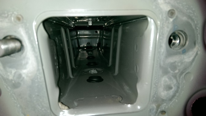 Vehicle frame opening with visible bolts and mounting points
