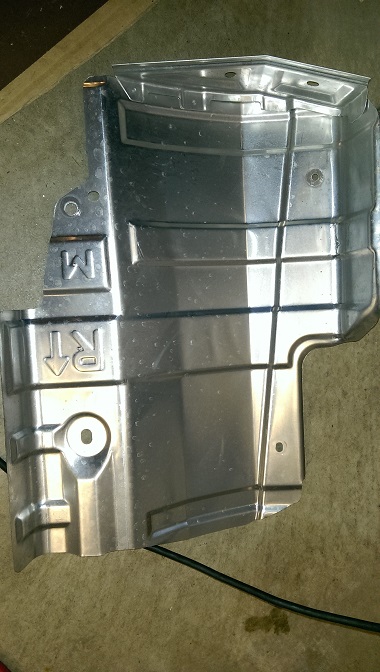 2015 Subaru Forester - Metal underbody shield with embossed markings, likely a replacement part.